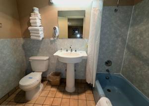 a bathroom with a sink and a toilet and a tub at Monroe Motel Near Seattle Everett WA in Monroe