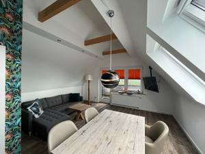 a living room with a table and a couch at Astrid's Appartements in Winterberg