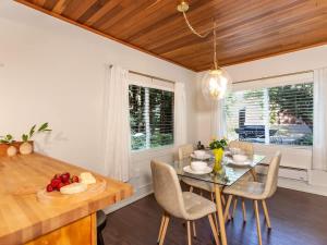 a dining room with a table and chairs at Birdhouse Cottage in Glacier
