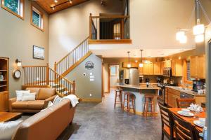 a kitchen and living room with a couch and a table at Avventura Chalet in Glacier
