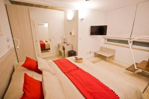 a bedroom with a large bed with red pillows at Apartment 81 in Mosta
