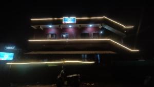 a building with lights on it in the dark at Heera BEACH WAVE STAY in Gokarn