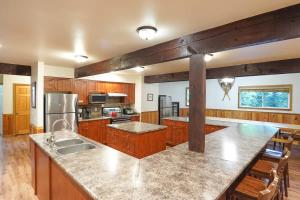 a large kitchen with wooden cabinets and a counter top at Evergreen Lodge in Deming