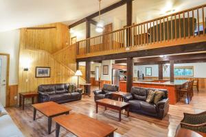 a living room filled with furniture and a staircase at Evergreen Lodge in Deming