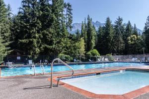 a swimming pool in a resort with trees at The Shuksan in Deming