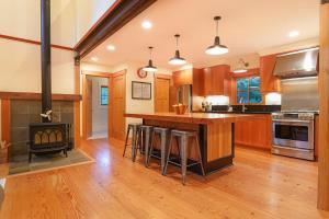 a kitchen with wooden cabinets and a wood stove at The Shuksan in Deming