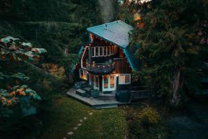 a small tree house with a light on it at Alpine Lodge in Glacier