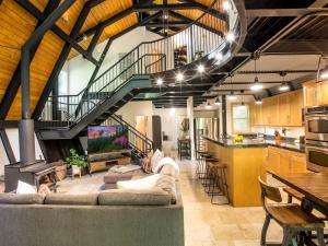 a large living room with a couch and a kitchen at Alpine Lodge in Glacier