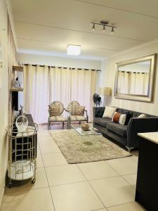 a living room with a couch and two chairs at CLASSY and COZY 3 in Fourways