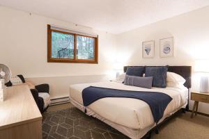a bedroom with a large bed and a window at Cedar Suite at Snowater in Glacier