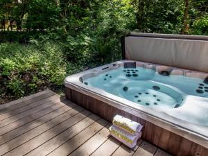 a jacuzzi tub sitting on a wooden deck at Church Mountain View Chalet in Glacier