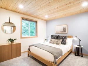 a bedroom with a large bed and a window at Church Mountain View Chalet in Glacier