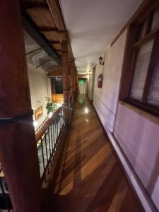 an empty hallway of a building with a wooden floor at Casa La Ronda in Quito