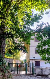 a fence in front of a building with a tree at Tiny home in Camigliatello Silano