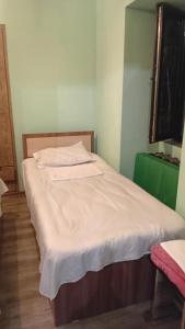 a bed with white sheets on it in a room at Ani guest house in Meghri