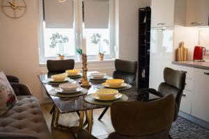 a dining room with a table and chairs at Apartman NOA in Novska +19 photos