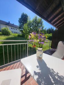 a vase filled with flowers sitting on a table at Family Apartment, 2 Bedrooms, 2 Bathrooms, Bavarian Forest in Mitterfirmiansreut