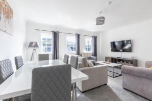 a living room with a couch and a table and chairs at Harbour View in Whitehaven