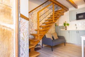a staircase in a living room with a couch at Apartamentos San Roque in Arenas de Cabrales