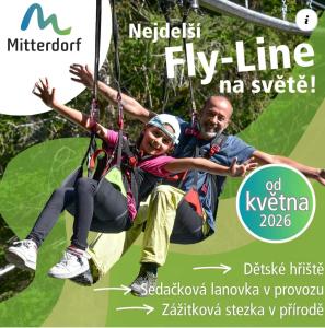 a man and a woman riding on a rope swing at Family Apartment, 2 Bedrooms, 2 Bathrooms, Bavarian Forest in Mitterfirmiansreut