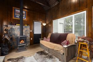 a living room with a couch and a fireplace at Stylish KC FarmhouseHugeFencedYard in Merriam