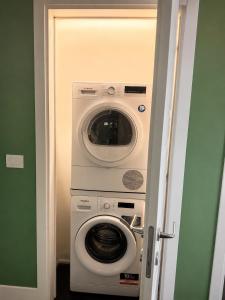 a washing machine and a washer in a room at Green House Historic Centre in Bologna