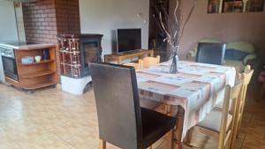 a dining room with a table and chairs at Domek nad jeziorem in Dorotowo