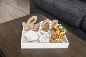 a table with a tray with a necklace and a bowl of food at Olathe corporate retreat in Olathe