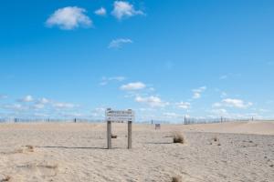 a sign in the sand at the beach at Panoramic Water Views w Private Beach in Chatham