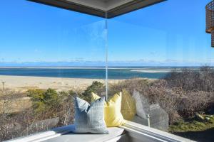 a window with a view of the beach at Panoramic Water Views w Private Beach in Chatham