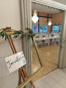 a mirror in a room with a tables and chairs at Rantakartano in Pori