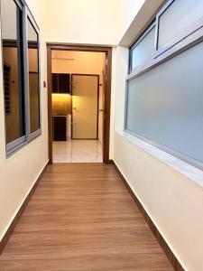 a corridor of a building with a window at Uni Stay Inn in Cochin +17 photos