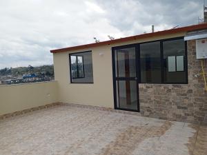 a house with glass doors on the side of it at Apartamentos Latacunga in Latacunga
