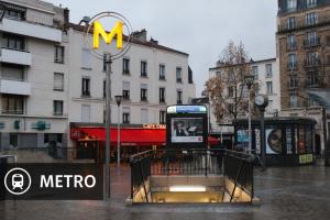 a metro sign on a street in a city at Studio cosy avec parking près de Paris Expo Porte de Versailles in Vanves