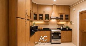 a kitchen with wooden cabinets and a stove top oven at Akhet Cairo Suites in Cairo