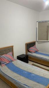 a room with two beds in a room at Casa Cómoda in Nabeul +5 photos