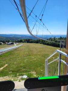 a view from the top of a gondola with a green field at Family Apartment, 2 Bedrooms, 2 Bathrooms, Bavarian Forest in Mitterfirmiansreut +39 photos