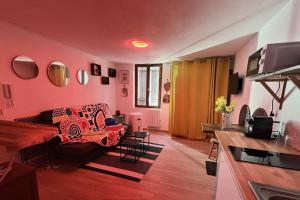 a living room with pink walls and a couch at Summer vibes Béziers centre in Béziers
