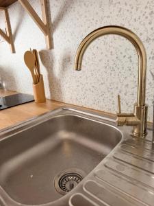 a sink with a faucet in a kitchen at Summer vibes Béziers centre in Béziers