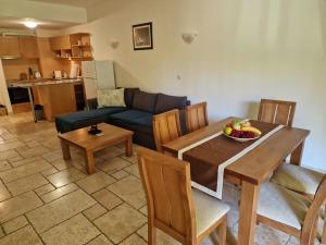 a living room with a table and a couch at Kaliakria Garden in Topola