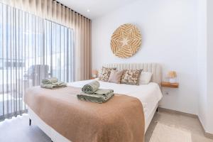 a bedroom with a large bed with towels on it at Luxe zuiderse villa in Dolores +87 photos