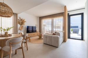 a living room with a couch and a table at Luxe zuiderse villa in Dolores