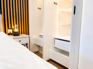 a bedroom with white cabinets and a bed at Apartmán Javorná Living in Čachrov