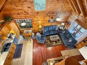 an overhead view of a living room and kitchen in a log cabin at UnBearably Cozy - pool table, fire pit, central location in Bryson City +13 photos