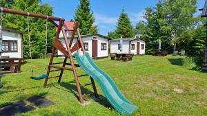 a playground with a slide in a yard at Siedlisko Białogóra in Białogóra