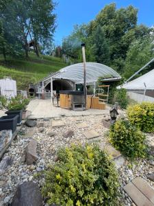 a dome shaped building with a tunnel in a garden at VINOPORT Apartmanház in Eger