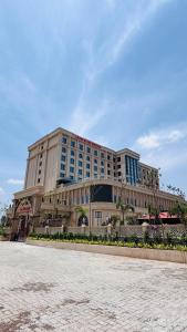 a large building in front of a building at Hotel Express Inn Heritage Aurangabad Airport in Aurangabad