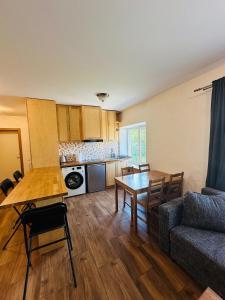 a living room with a table and a couch at Rožu namu apartamenti 6 in Kuldīga