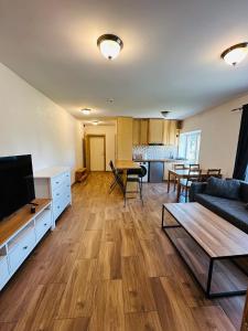 a living room with a couch and a tv at Rožu namu apartamenti 6 in Kuldīga