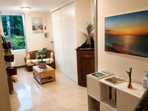 a living room with a couch and a table at La Diligence in Lepin-le-Lac